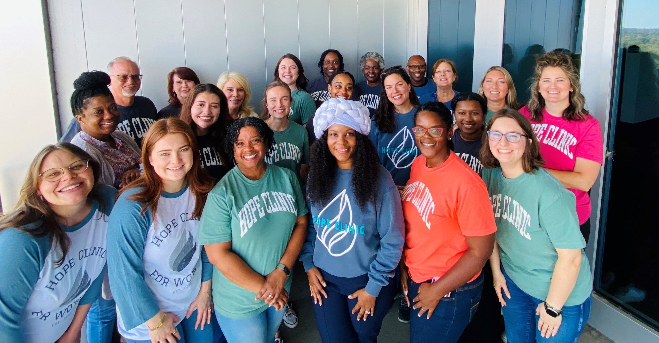 Hope Clinic for Women team smiling together at the clinic.
