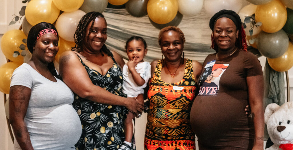 Families and volunteers at the Hope Clinic for Women Baby Shower 2025 smiling, sharing conversations, and receiving baby supplies and parenting resources.
